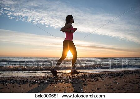 Stock Image - Young Girl Running On The Beach. Fotosearch