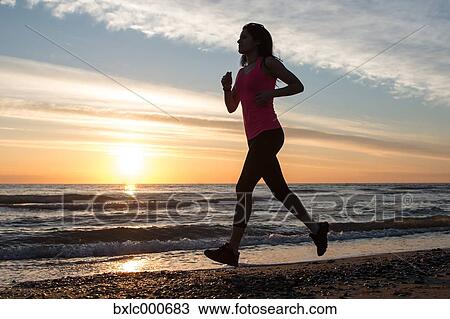 Stock Image - Young Girl Running On The Beach. Fotosearch