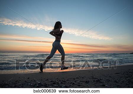 Stock Photo - Young Girl Running On The Beach. Fotosearch