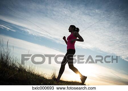 Stock Image - Young Girl Running On The Sand. Fotosearch