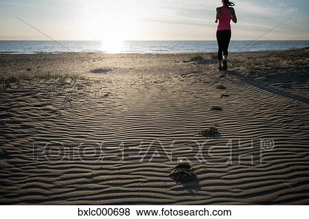 Young Girl Running On The Sand View Large Photo Image Stock Photo - Young Girl Running On The Sand. Fotosearch