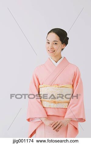 Picture - Young Japanese woman in a traditional kimono against white background. Fotosearch
