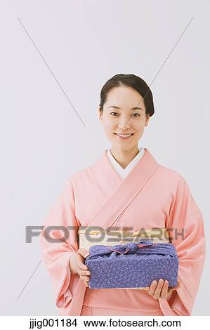 Young Japanese woman in a traditional kimono against white background View Large Photo Image Picture - Young Japanese woman in a traditional kimono against white background. Fotosearch