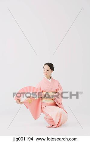 Young Japanese woman in a traditional kimono against white background View Large Photo Image Picture - Young Japanese woman in a traditional kimono against white background. Fotosearch