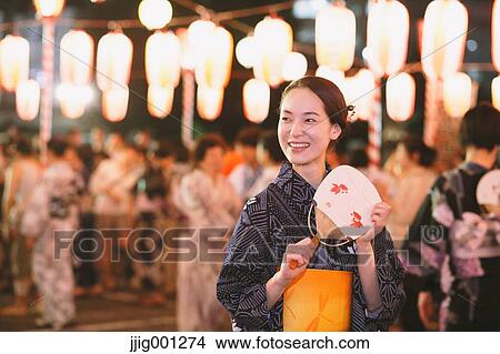 Young Japanese woman in a traditional kimono at a summer festival View Large Photo Image Picture - Young Japanese woman in a traditional kimono at a summer festival. Fotosearch