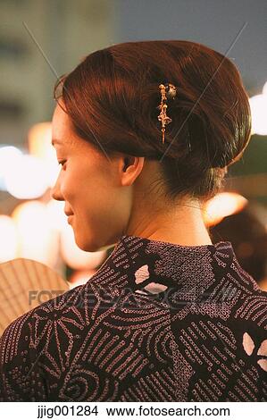 Young Japanese woman in a traditional kimono at a summer festival View Large Photo Image Picture - Young Japanese woman in a traditional kimono at a summer festival. Fotosearch