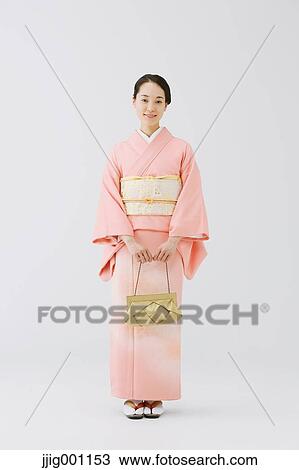 Young Japanese woman in a traditional kimono against white background View Large Photo Image Stock Image - Young Japanese woman in a traditional kimono against white background. Fotosearch