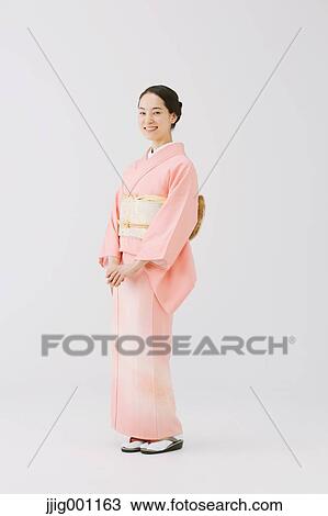Young Japanese woman in a traditional kimono against white background View Large Photo Image Stock Image - Young Japanese woman in a traditional kimono against white background. Fotosearch