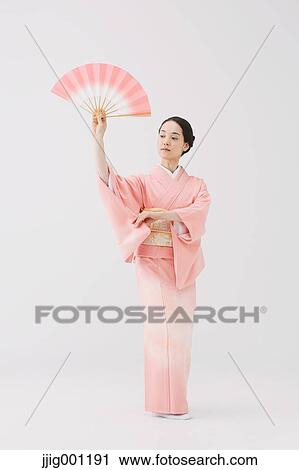 Young Japanese woman in a traditional kimono against white background View Large Photo Image Stock Image - Young Japanese woman in a traditional kimono against white background. Fotosearch
