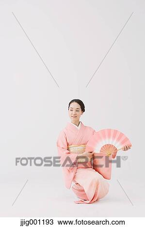 Young Japanese woman in a traditional kimono against white background View Large Photo Image Stock Image - Young Japanese woman in a traditional kimono against white background. Fotosearch