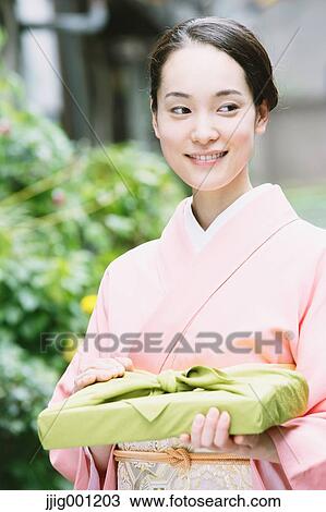 Young Japanese woman in a traditional kimono View Large Photo Image Stock Image - Young Japanese woman in a traditional kimono. Fotosearch