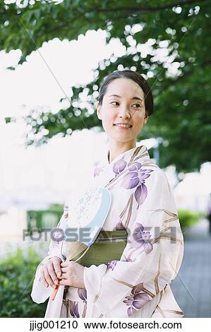 Stock Image - Young Japanese woman in a traditional kimono. Fotosearch