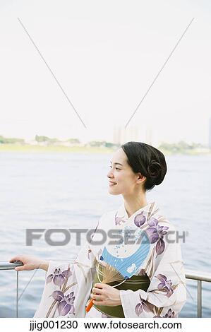 Young Japanese woman in a traditional kimono View Large Photo Image Stock Image - Young Japanese woman in a traditional kimono. Fotosearch
