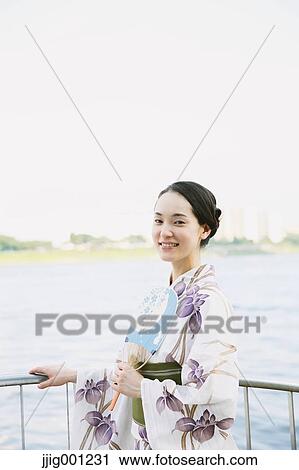 Young Japanese woman in a traditional kimono View Large Photo Image Stock Image - Young Japanese woman in a traditional kimono. Fotosearch
