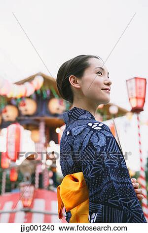 Young Japanese woman in a traditional kimono at a summer festival View Large Photo Image Stock Image - Young Japanese woman in a traditional kimono at a summer festival. Fotosearch