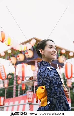 Young Japanese woman in a traditional kimono at a summer festival View Large Photo Image Stock Image - Young Japanese woman in a traditional kimono at a summer festival. Fotosearch