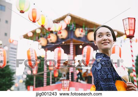 Young Japanese woman in a traditional kimono at a summer festival View Large Photo Image Stock Image - Young Japanese woman in a traditional kimono at a summer festival. Fotosearch