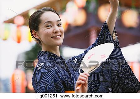 Young Japanese woman in a traditional kimono at a summer festival View Large Photo Image Stock Image - Young Japanese woman in a traditional kimono at a summer festival. Fotosearch
