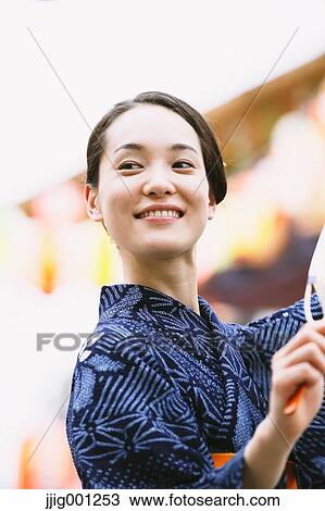 Young Japanese woman in a traditional kimono at a summer festival View Large Photo Image Stock Image - Young Japanese woman in a traditional kimono at a summer festival. Fotosearch