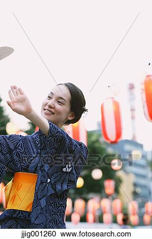 Young Japanese woman in a traditional kimono at a summer festival View Large Photo Image Stock Image - Young Japanese woman in a traditional kimono at a summer festival. Fotosearch