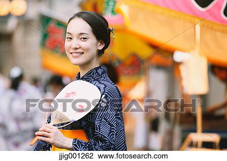 Young Japanese woman in a traditional kimono at a summer festival View Large Photo Image Stock Image - Young Japanese woman in a traditional kimono at a summer festival. Fotosearch