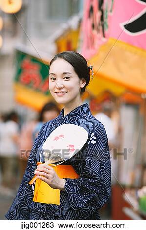 Young Japanese woman in a traditional kimono at a summer festival View Large Photo Image Stock Image - Young Japanese woman in a traditional kimono at a summer festival. Fotosearch