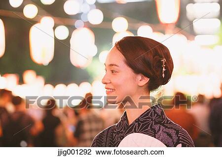 Young Japanese woman in a traditional kimono at a summer festival View Large Photo Image Stock Image - Young Japanese woman in a traditional kimono at a summer festival. Fotosearch