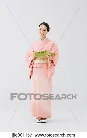 Young Japanese woman in a traditional kimono against white background View Large Photo Image Stock Photo - Young Japanese woman in a traditional kimono against white background. Fotosearch