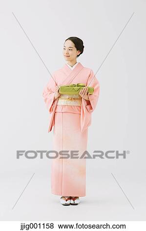 Young Japanese woman in a traditional kimono against white background View Large Photo Image Stock Photo - Young Japanese woman in a traditional kimono against white background. Fotosearch