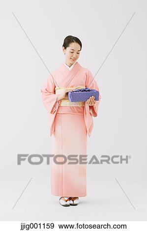 Young Japanese woman in a traditional kimono against white background View Large Photo Image Stock Photo - Young Japanese woman in a traditional kimono against white background. Fotosearch