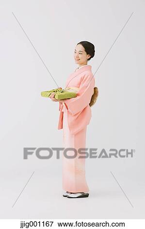 Young Japanese woman in a traditional kimono against white background View Large Photo Image Stock Photo - Young Japanese woman in a traditional kimono against white background. Fotosearch