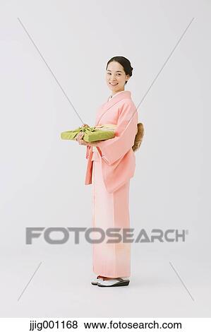 Stock Photo - Young Japanese woman in a traditional kimono against white background. Fotosearch