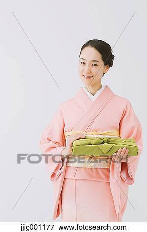 Stock Photo - Young Japanese woman in a traditional kimono against white background. Fotosearch