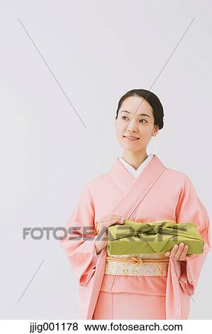 Stock Photo - Young Japanese woman in a traditional kimono against white background. Fotosearch