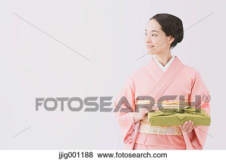 Young Japanese woman in a traditional kimono against white background View Large Photo Image Stock Photo - Young Japanese woman in a traditional kimono against white background. Fotosearch