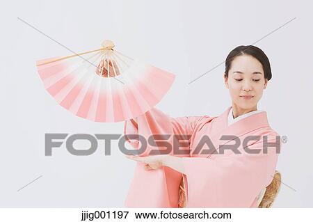 Stock Photo - Young Japanese woman in a traditional kimono against white background. Fotosearch