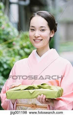 Stock Photo - Young Japanese woman in a traditional kimono. Fotosearch