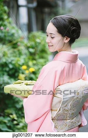 Young Japanese woman in a traditional kimono View Large Photo Image Stock Photo - Young Japanese woman in a traditional kimono. Fotosearch