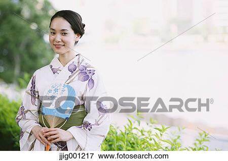 Young Japanese woman in a traditional kimono View Large Photo Image Stock Photo - Young Japanese woman in a traditional kimono. Fotosearch