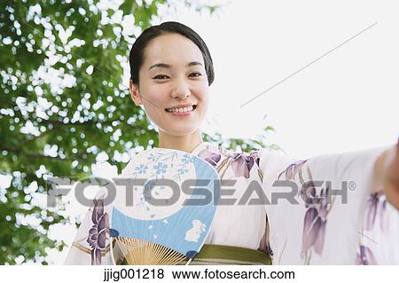 Young Japanese woman in a traditional kimono View Large Photo Image Stock Photo - Young Japanese woman in a traditional kimono. Fotosearch