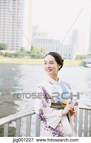 Young Japanese woman in a traditional kimono View Large Photo Image Stock Photo - Young Japanese woman in a traditional kimono. Fotosearch