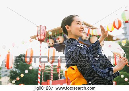 Young Japanese woman in a traditional kimono at a summer festival View Large Photo Image Stock Photo - Young Japanese woman in a traditional kimono at a summer festival. Fotosearch