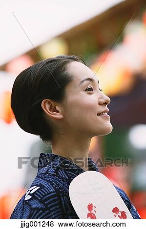 Young Japanese woman in a traditional kimono at a summer festival View Large Photo Image Stock Photo - Young Japanese woman in a traditional kimono at a summer festival. Fotosearch