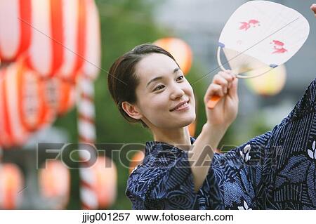 Young Japanese woman in a traditional kimono at a summer festival View Large Photo Image Stock Photo - Young Japanese woman in a traditional kimono at a summer festival. Fotosearch
