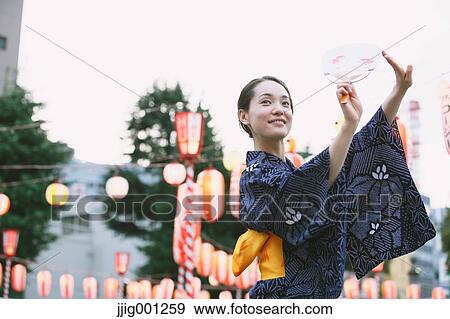 Young Japanese woman in a traditional kimono at a summer festival View Large Photo Image Stock Photo - Young Japanese woman in a traditional kimono at a summer festival. Fotosearch