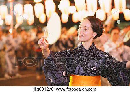 Young Japanese woman in a traditional kimono at a summer festival View Large Photo Image Stock Photo - Young Japanese woman in a traditional kimono at a summer festival. Fotosearch