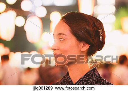 Young Japanese woman in a traditional kimono at a summer festival View Large Photo Image Stock Photo - Young Japanese woman in a traditional kimono at a summer festival. Fotosearch