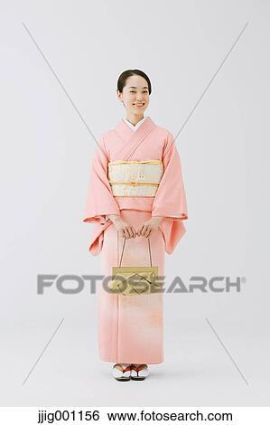 Young Japanese woman in a traditional kimono against white background View Large Photo Image Stock Photograph - Young Japanese woman in a traditional kimono against white background. Fotosearch