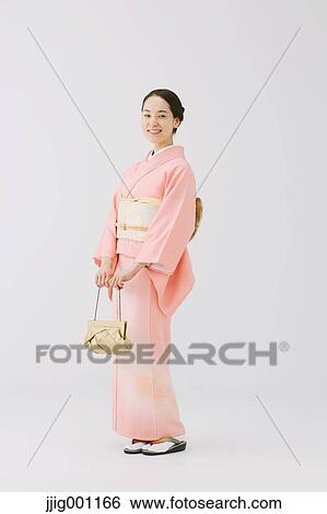 Young Japanese woman in a traditional kimono against white background View Large Photo Image Stock Photograph - Young Japanese woman in a traditional kimono against white background. Fotosearch
