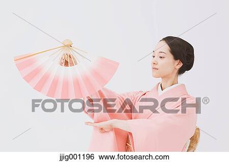Young Japanese woman in a traditional kimono against white background View Large Photo Image Stock Photograph - Young Japanese woman in a traditional kimono against white background. Fotosearch
